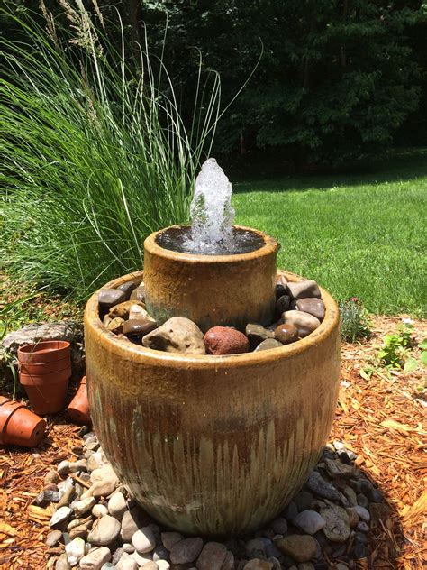 Using the wood drill bit, make a hole in the top of the wine barrel. . Diy fountain ideas